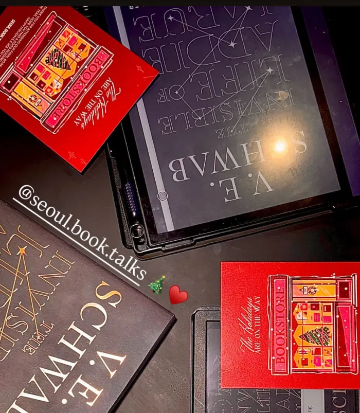 Copies of The Invisible Life of Addie LaRue on a cafe table